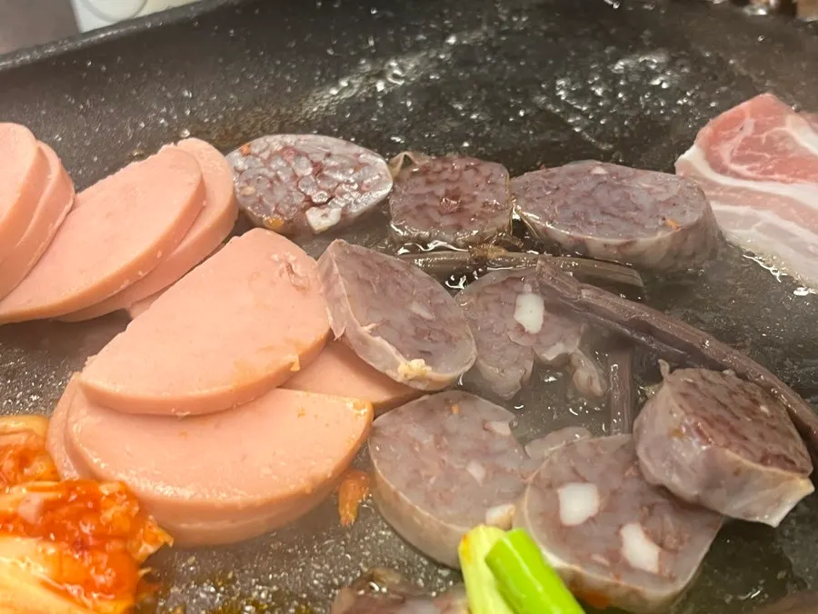 Sundae and pink sausage on the grill