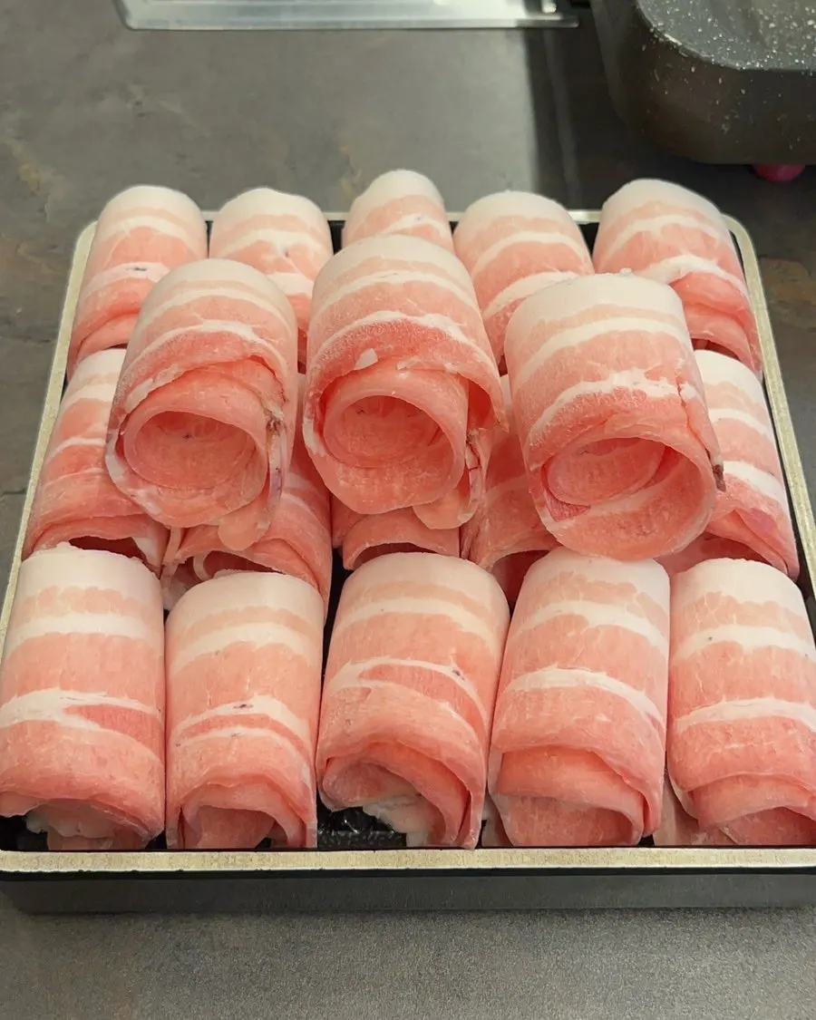 Plate of thinly sliced albam daepae pork belly