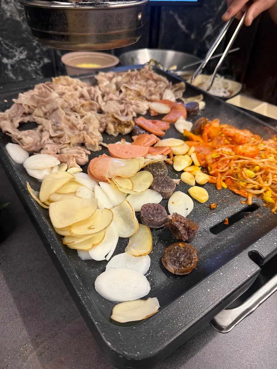 Duroc acorn-fed thinly-sliced pork belly on the grill