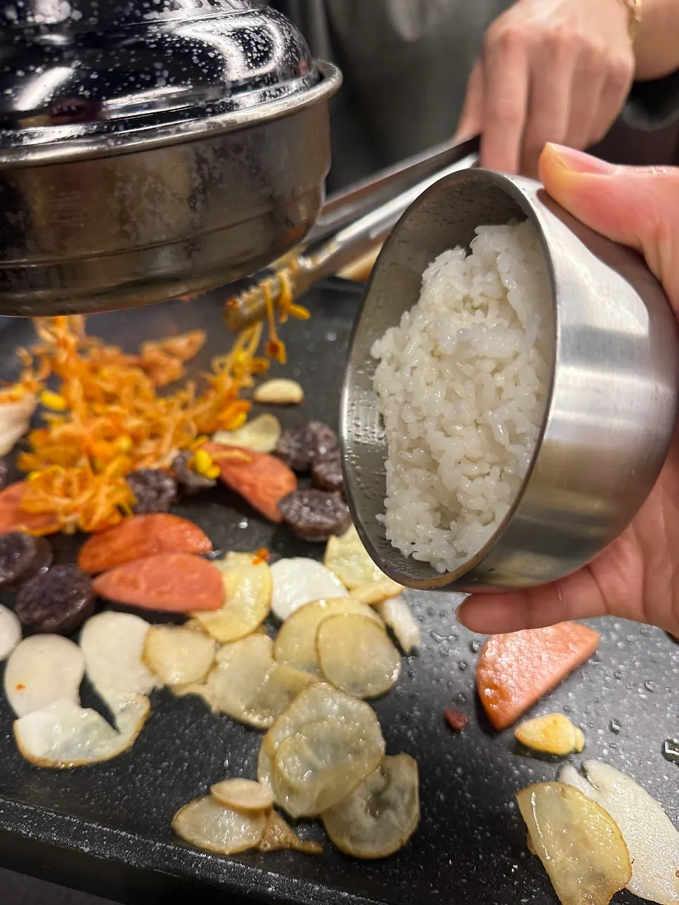 Kimchi fried rice being stirred on the grill