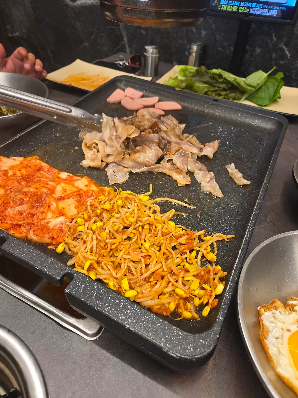 Kimchi and bean sprouts grilled together with the pork belly