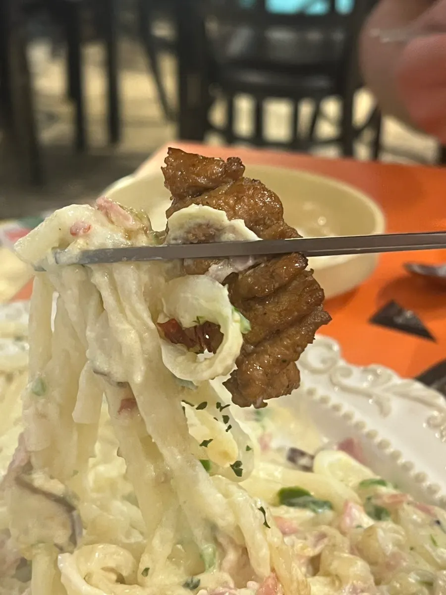 A piece of pork rib dipped in soy sauce