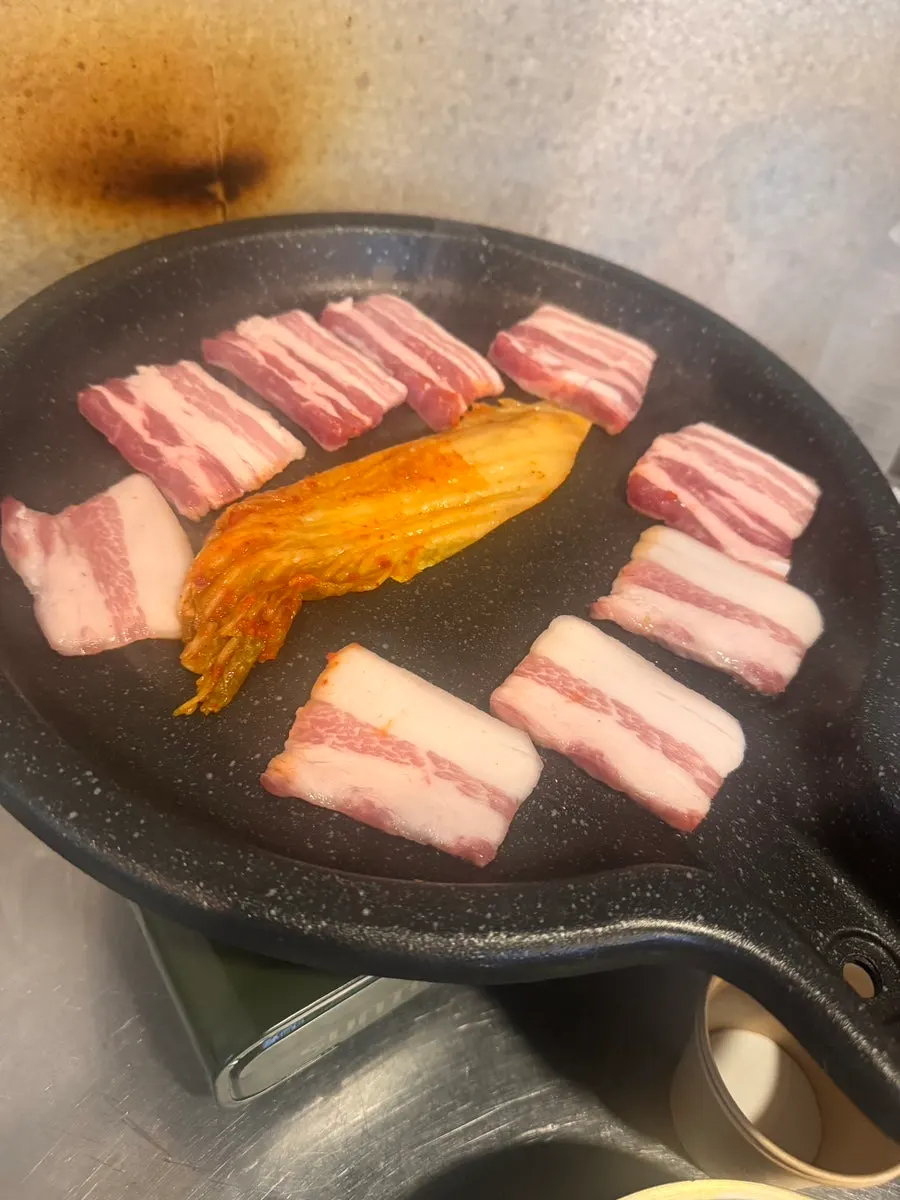 Scene of pork belly being grilled at Donnamu Jip