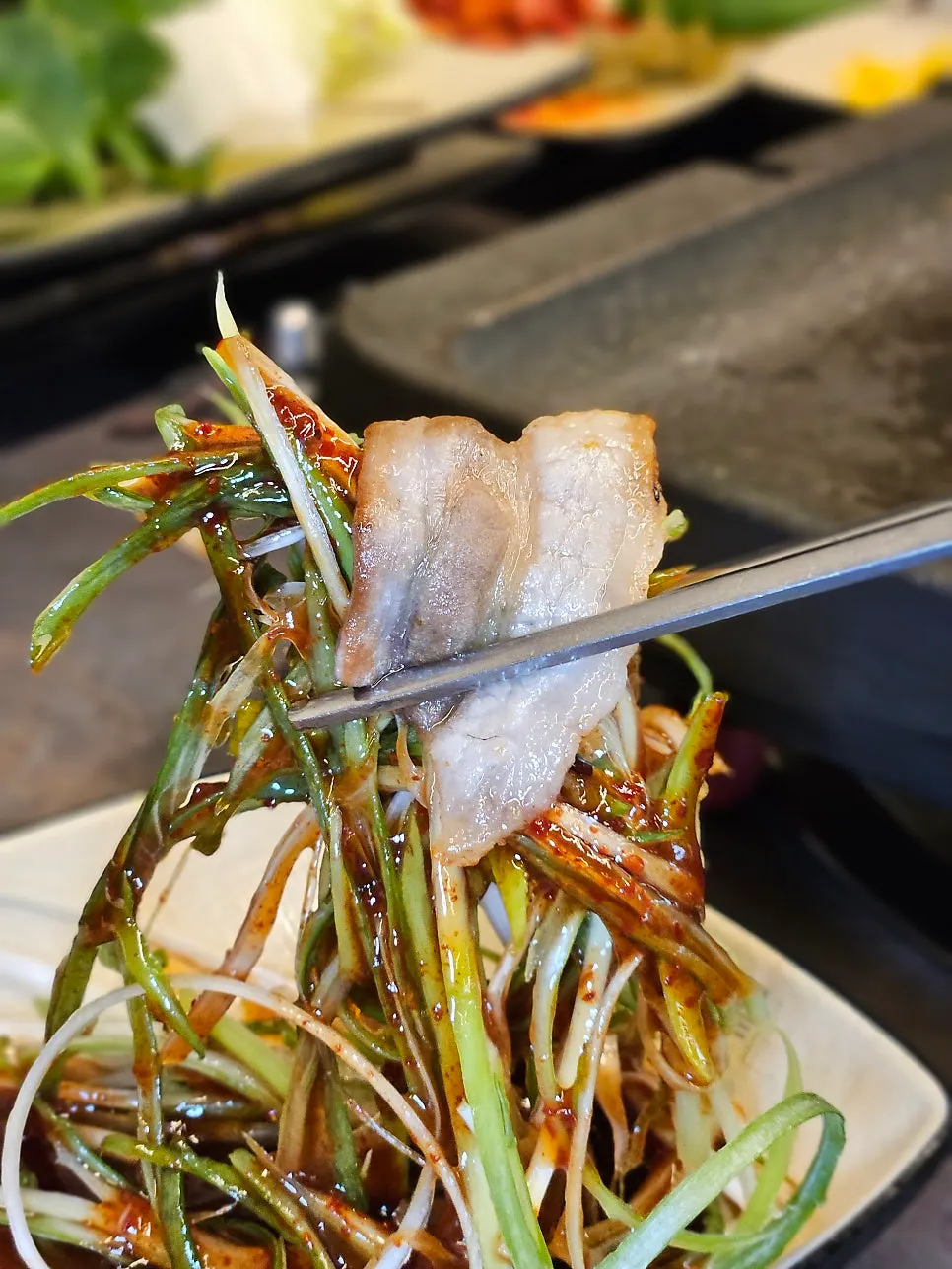 A savory bite of thin-sliced pork belly