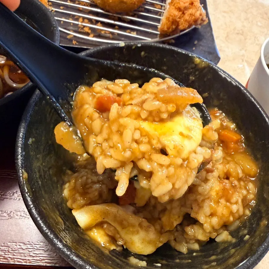 Chopsticks dipping noodles into the buckwheat broth