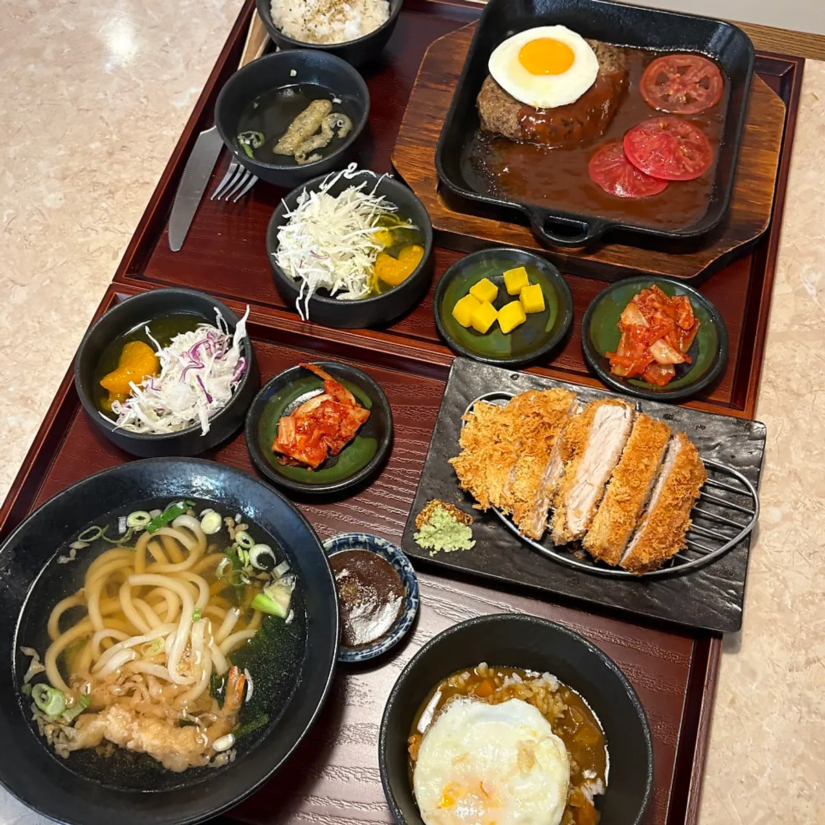 Full table spread of the combo set udon and hamburg steak set