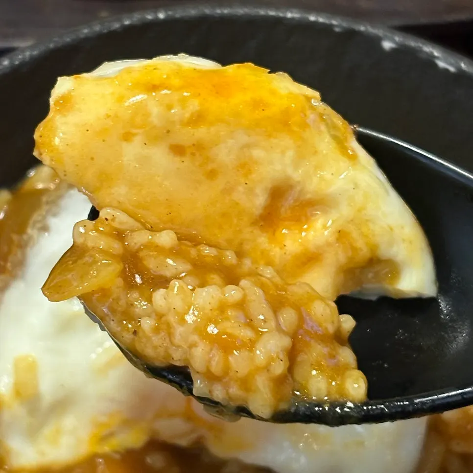 Curry rice topped with a soft-boiled fried egg