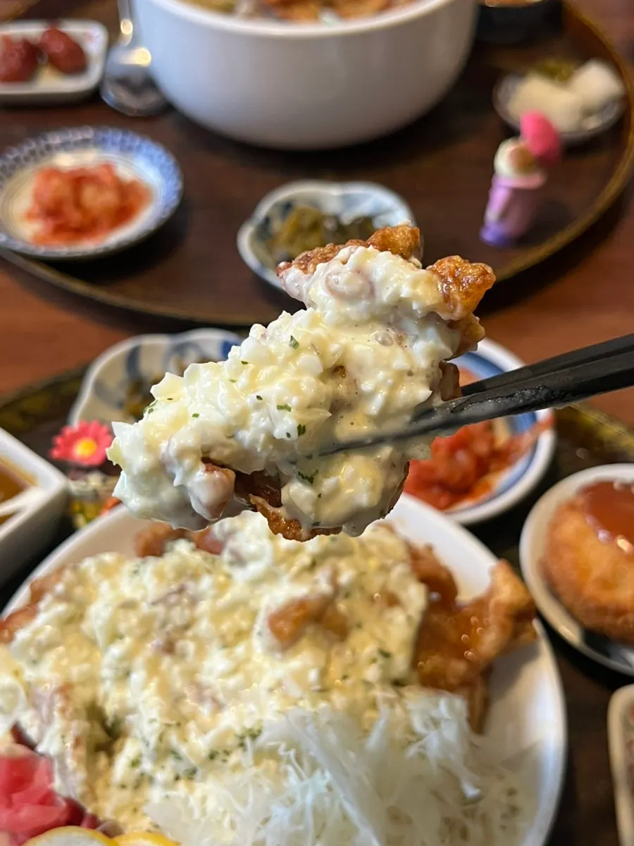 A piece of chicken nanban coated in egg white sauce