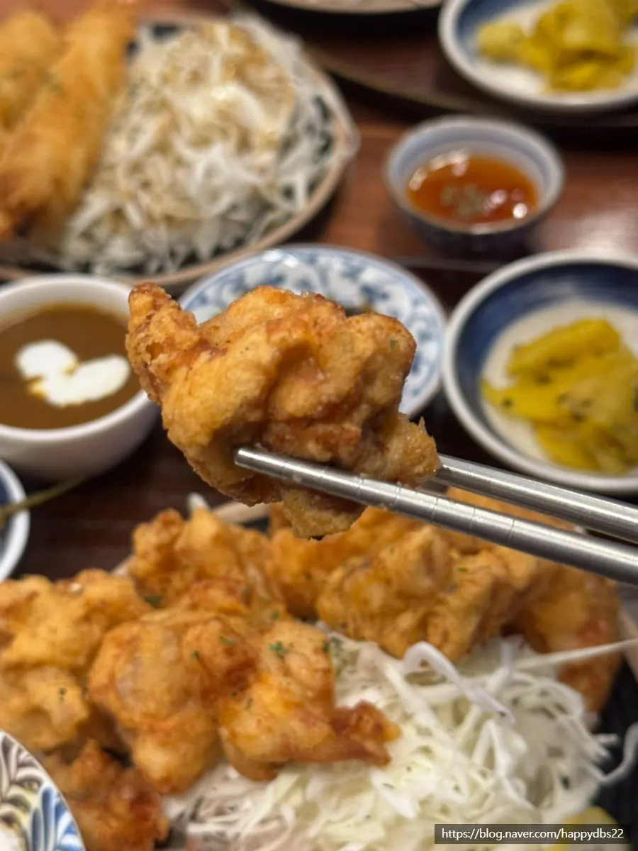 Karaage dipped in sauce with side dishes