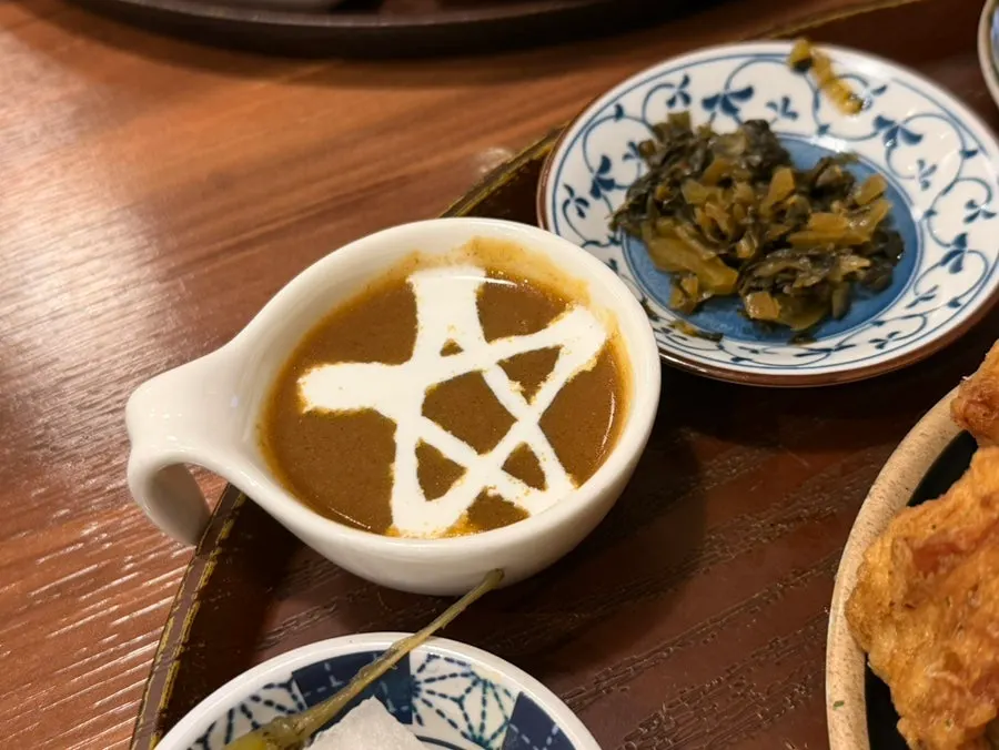 An assortment of side dishes and curry bowls