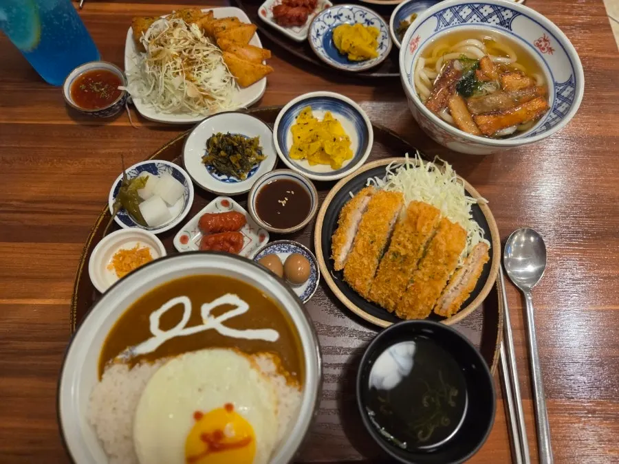 Set meal spread with side dishes, soup, rice and pudding