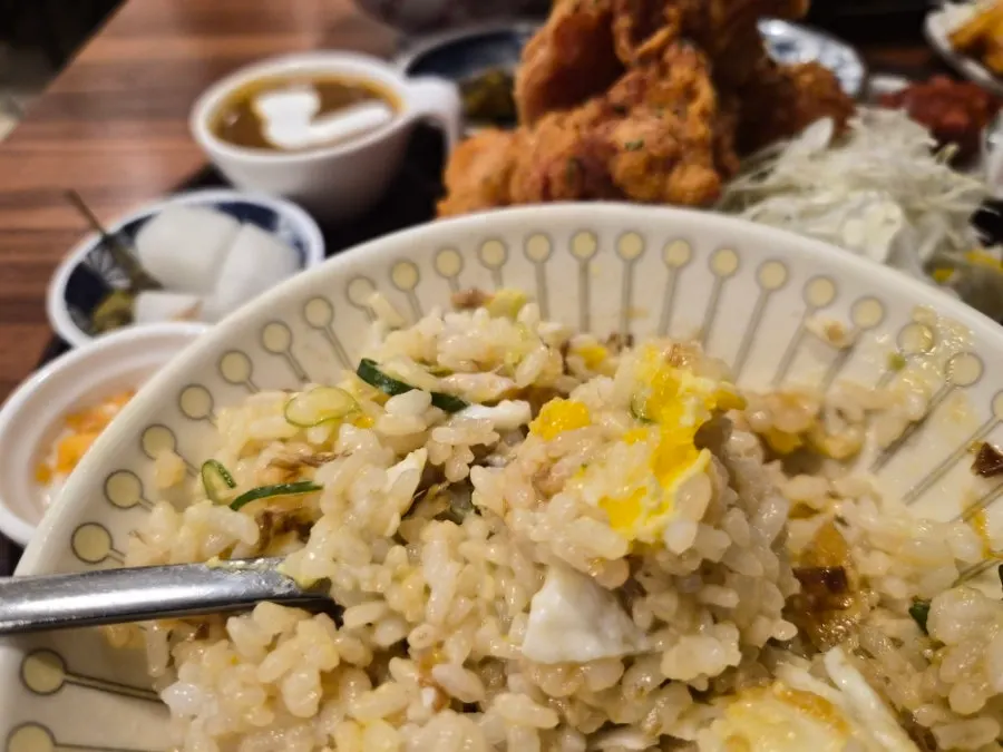 A bite of soy egg rice eaten alongside karaage