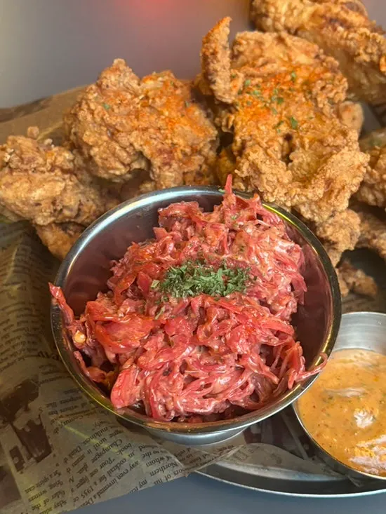 Chicken strips served with two dipping sauces and coleslaw