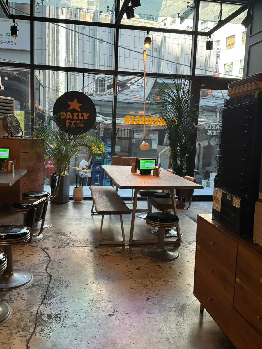 Table seating lit by floor-to-ceiling windows