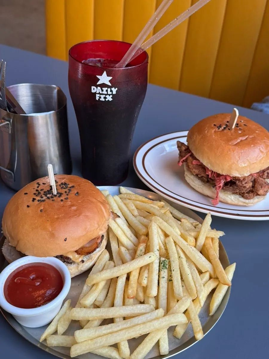 Table spread with the bacon cheeseburger set and chicken burger