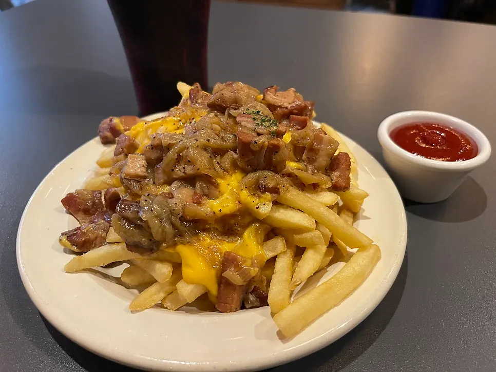 Bacon cheese fries topped with melted cheese