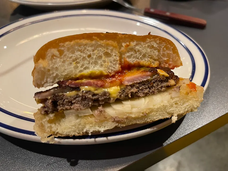Grilled onions visible inside the burger
