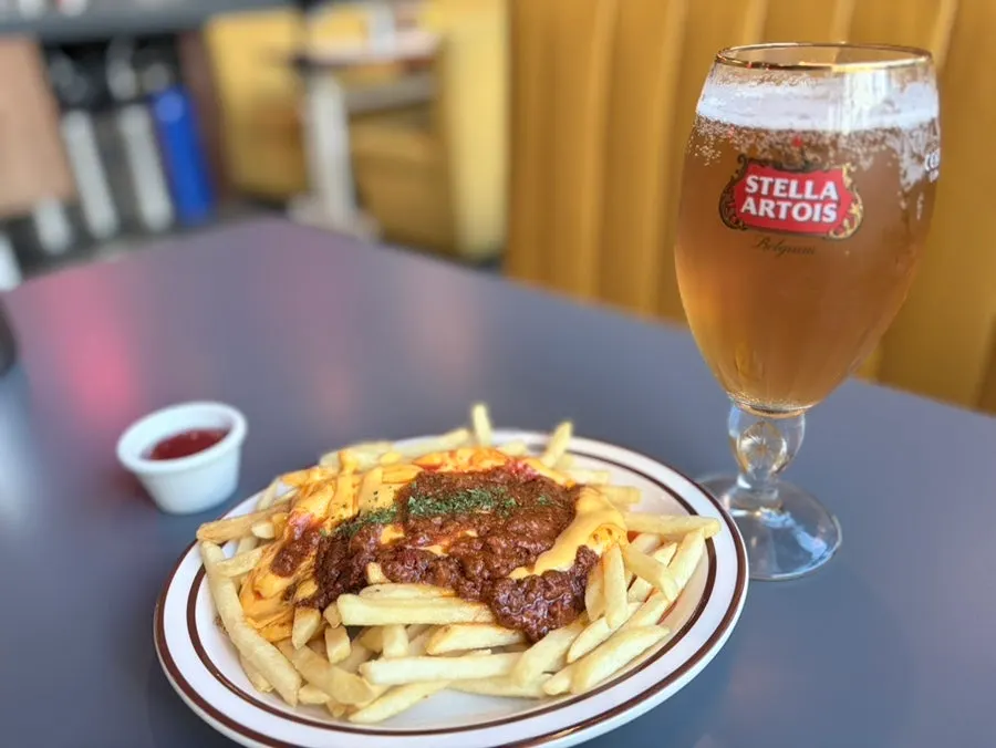 Fries piled with chili cheese sauce