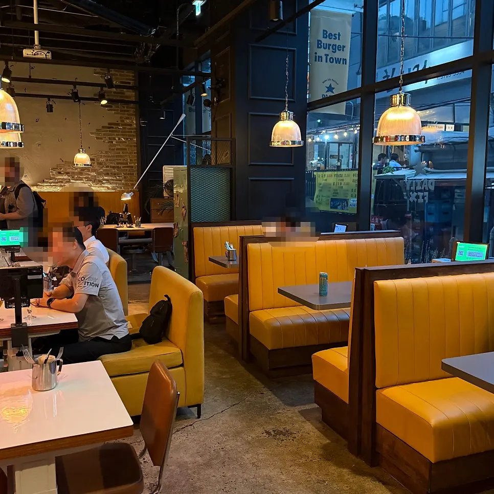 Interior with concrete walls and yellow booth seats