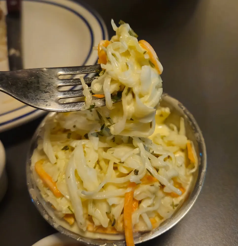A bowl of coleslaw served alongside the burgers