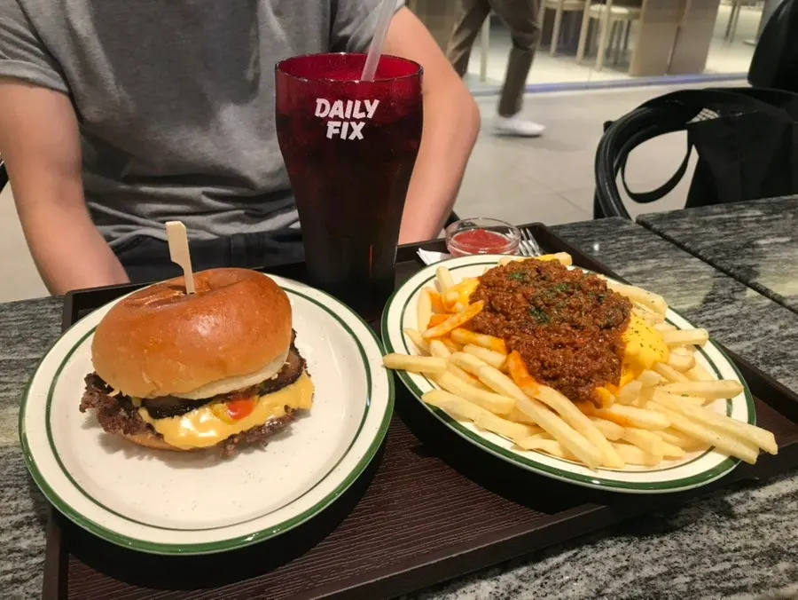 A spread of bacon cheeseburger and pulled pork sandwich