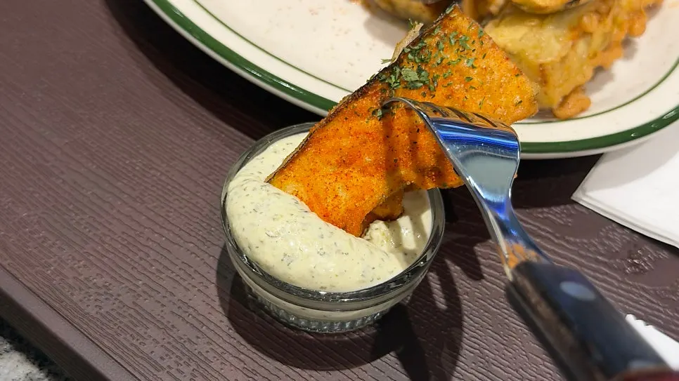 Thick special sauce served alongside the eggplant fritters