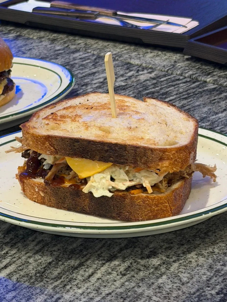 Pulled pork sandwich grilled on rye toast