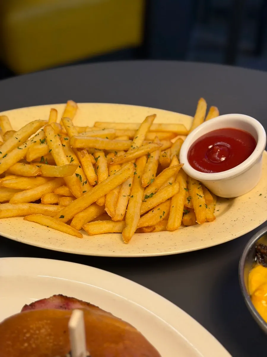 Bacon cheese fries with cheese sauce served on the side