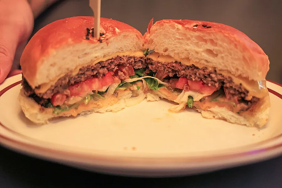 Cross-section of the classic burger with tomato and vegetables