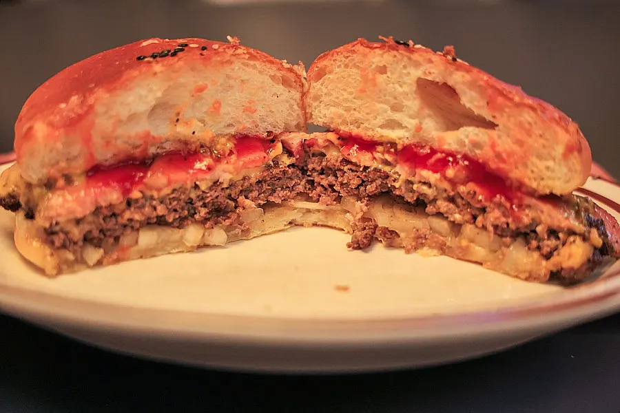 Cross-section of the bacon cheeseburger with thick house-made bacon