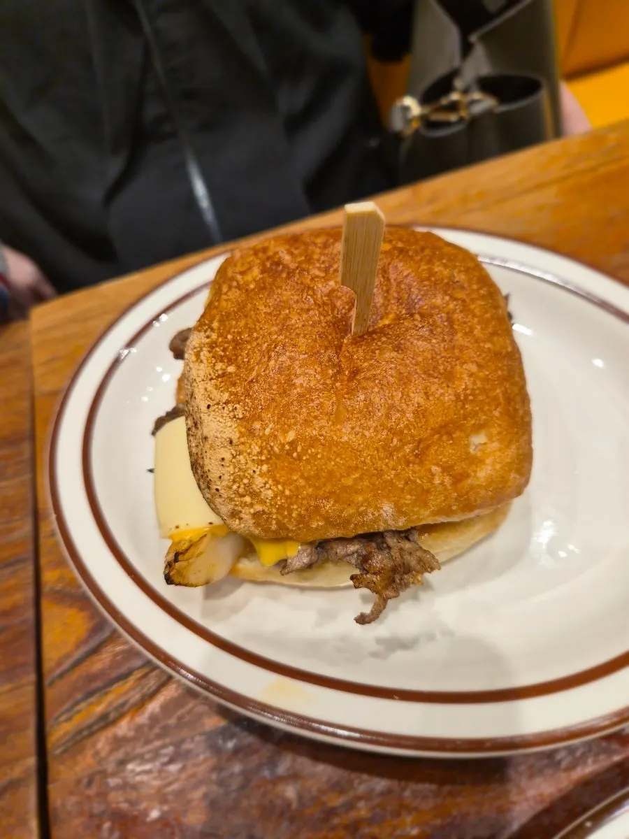 Sautéed onions and cheese inside the Philly cheesesteak sandwich