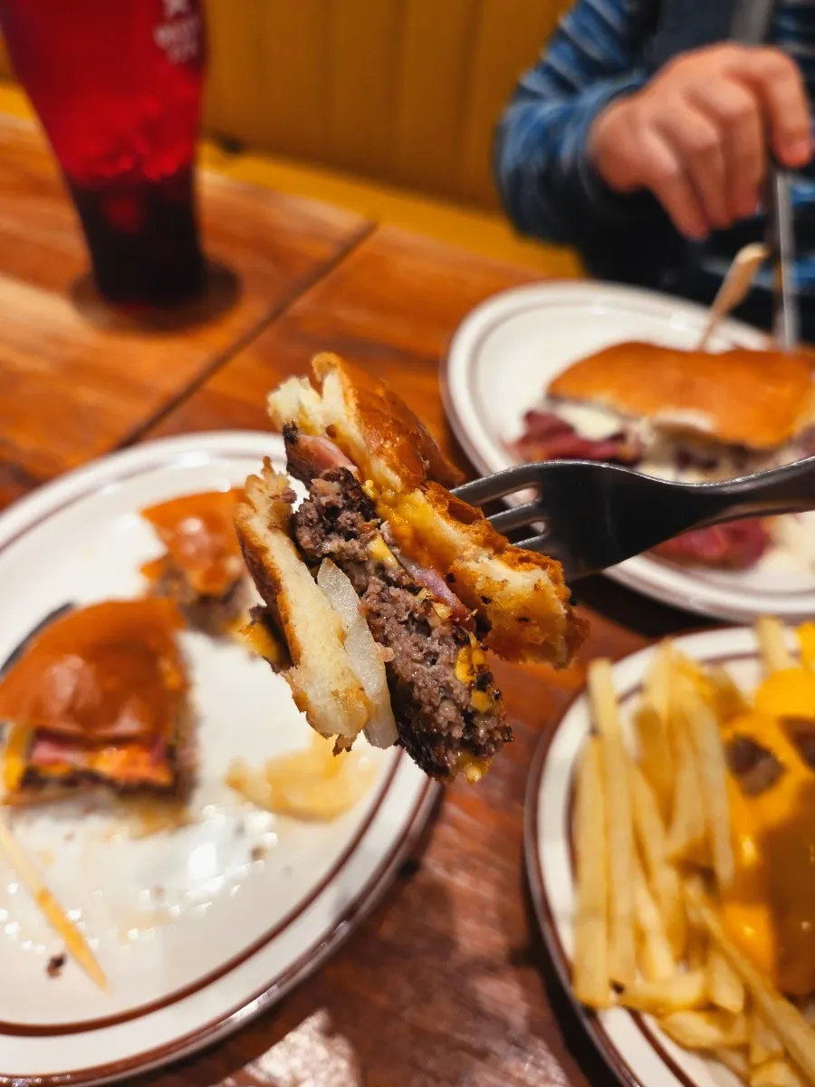 Cross-section of the bacon cheeseburger showing patty and handmade bacon