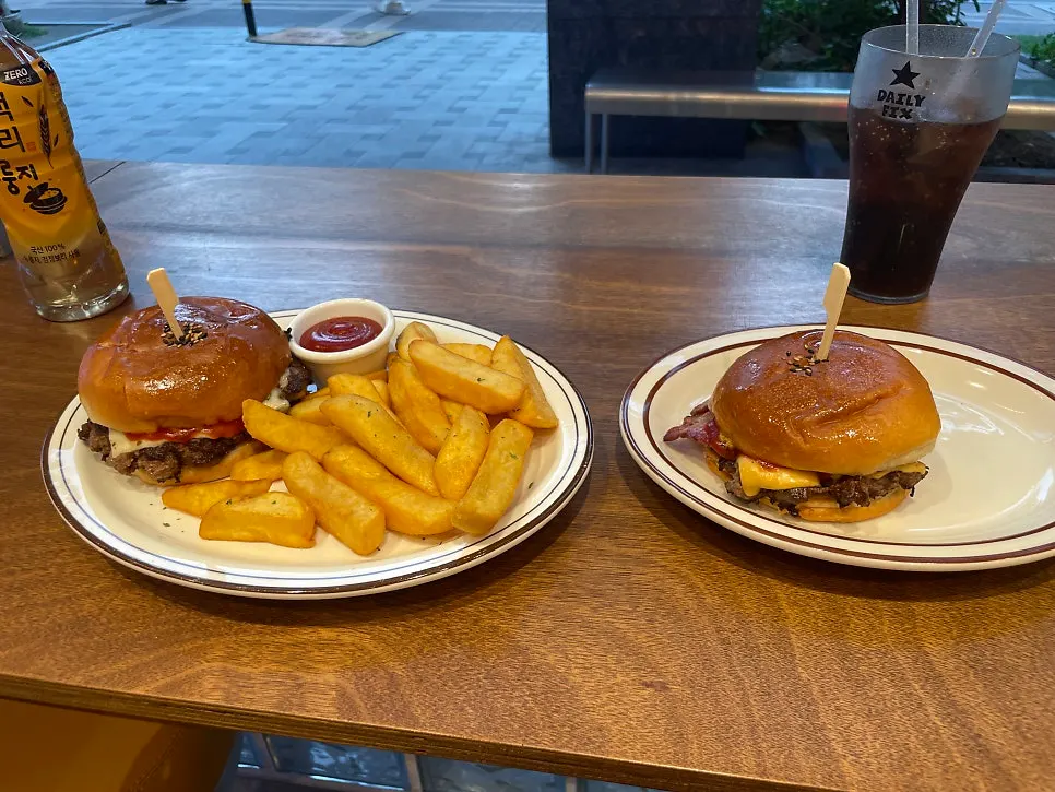 Double cheeseburger, bacon cheeseburger, and 18fries laid out together