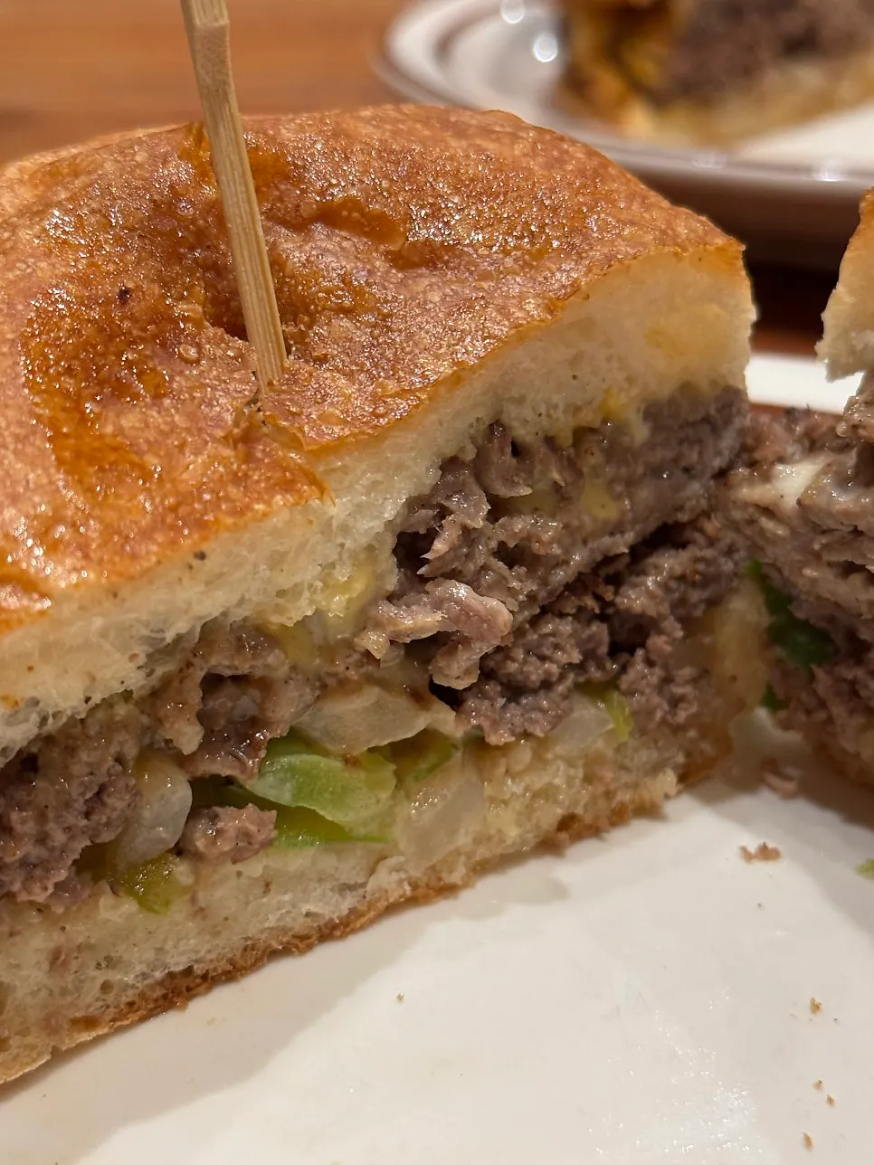 Philly cheesesteak sandwich held in hand