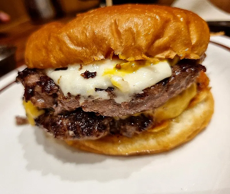 Double cheeseburger too tall to bite in one go