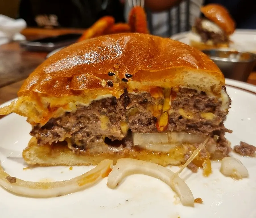 Cross-section of the halved burger showing patty and melting cheese