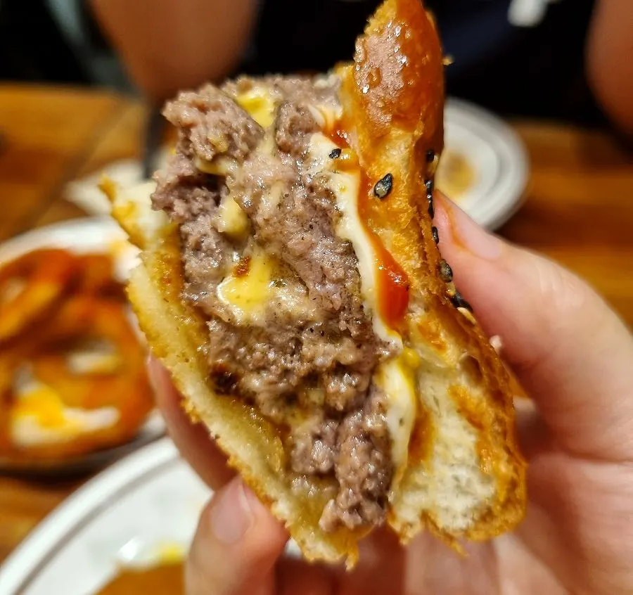 Double cheeseburger with a bite taken out of it