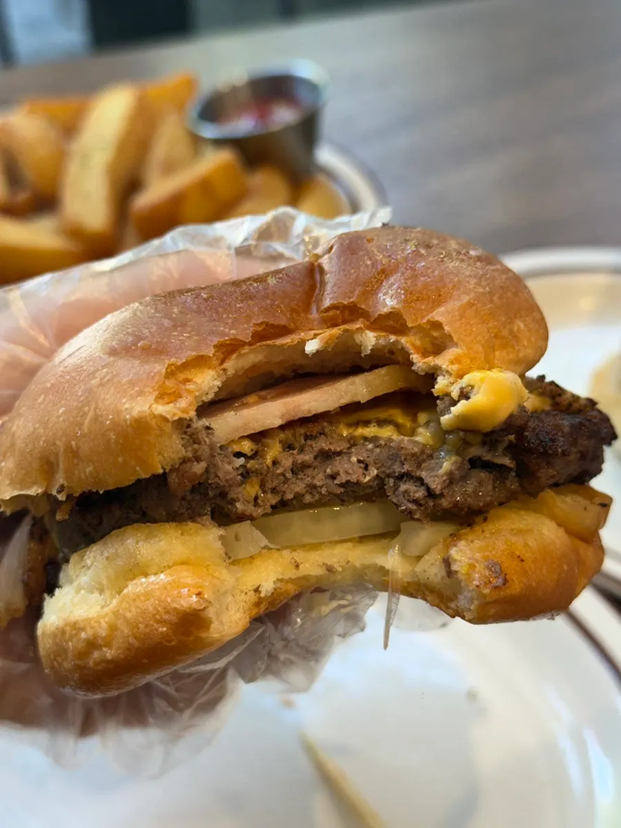 A bite taken out of the Bacon Cheese Burger