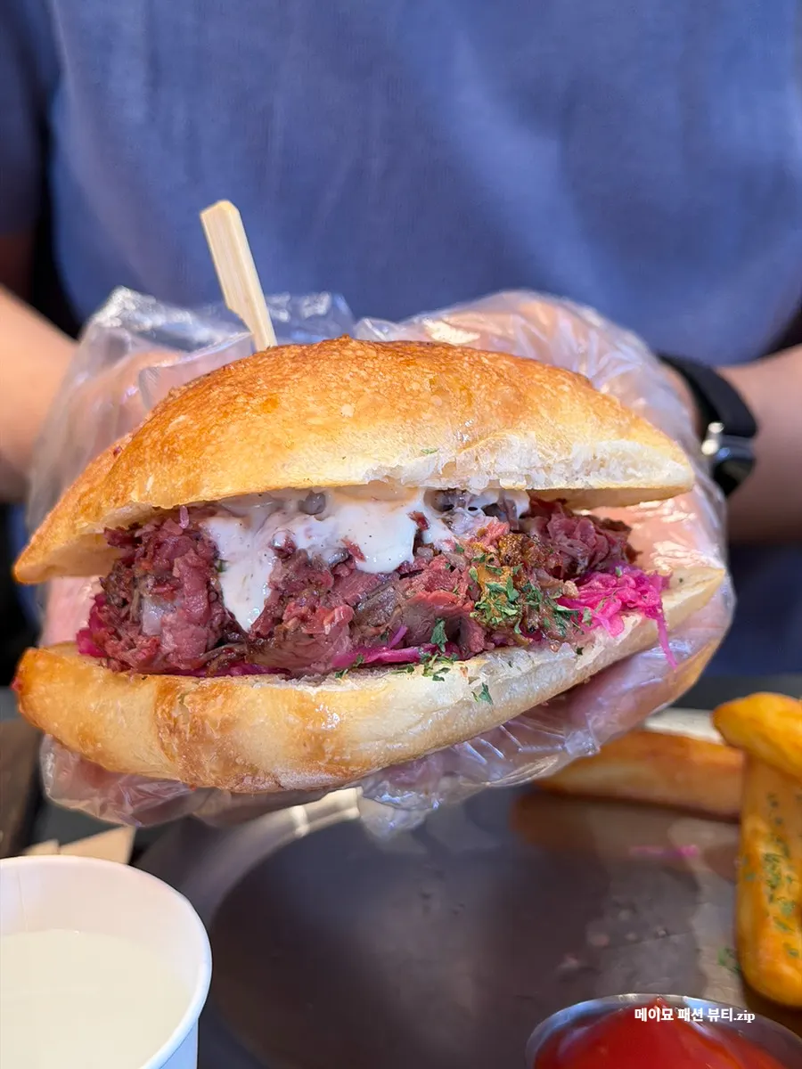 Large Pastrami Sandwich requiring both hands to hold
