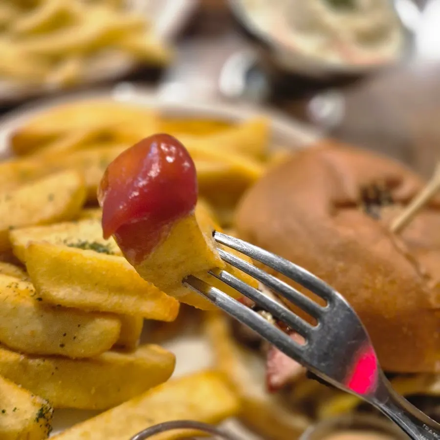 Thick fries dipped into the signature sauce
