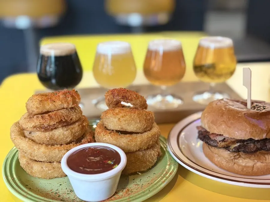 Table set with bacon cheeseburger and onion rings order