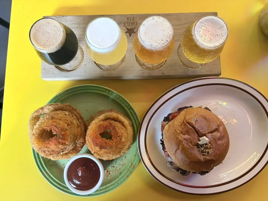 Beer sampler, burger, and onion rings all together