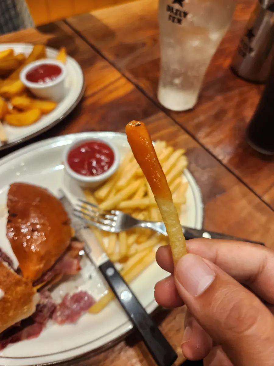 Lifting up the pastrami sandwich