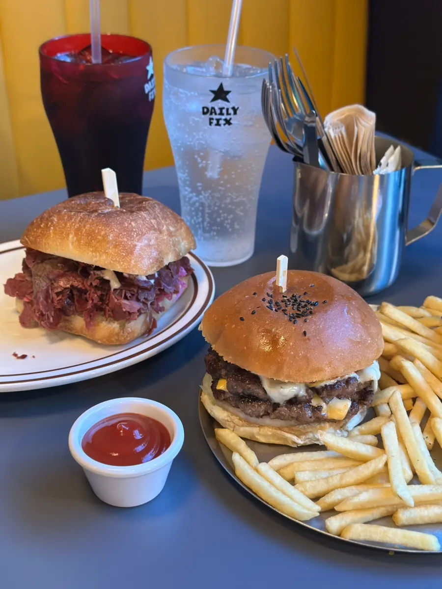 Double cheese burger and pastrami sandwich served together
