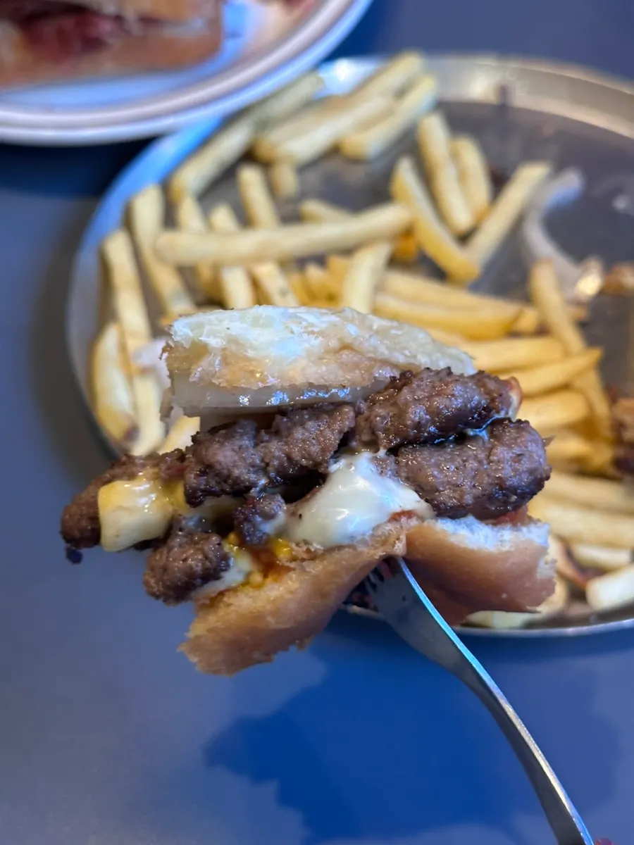 Cross-section of the burger with melted American and Swiss cheese
