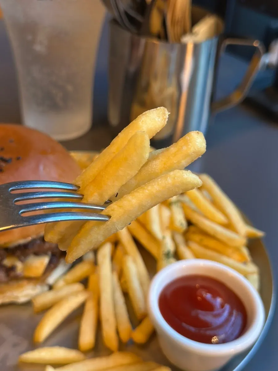 Bite of the double cheese burger showing raw onion