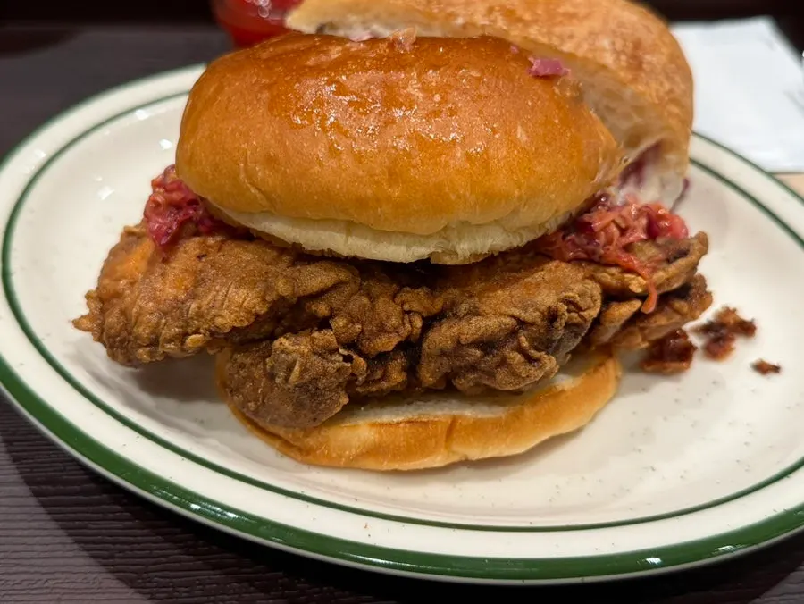 Inside the chicken burger with sauce and vegetables