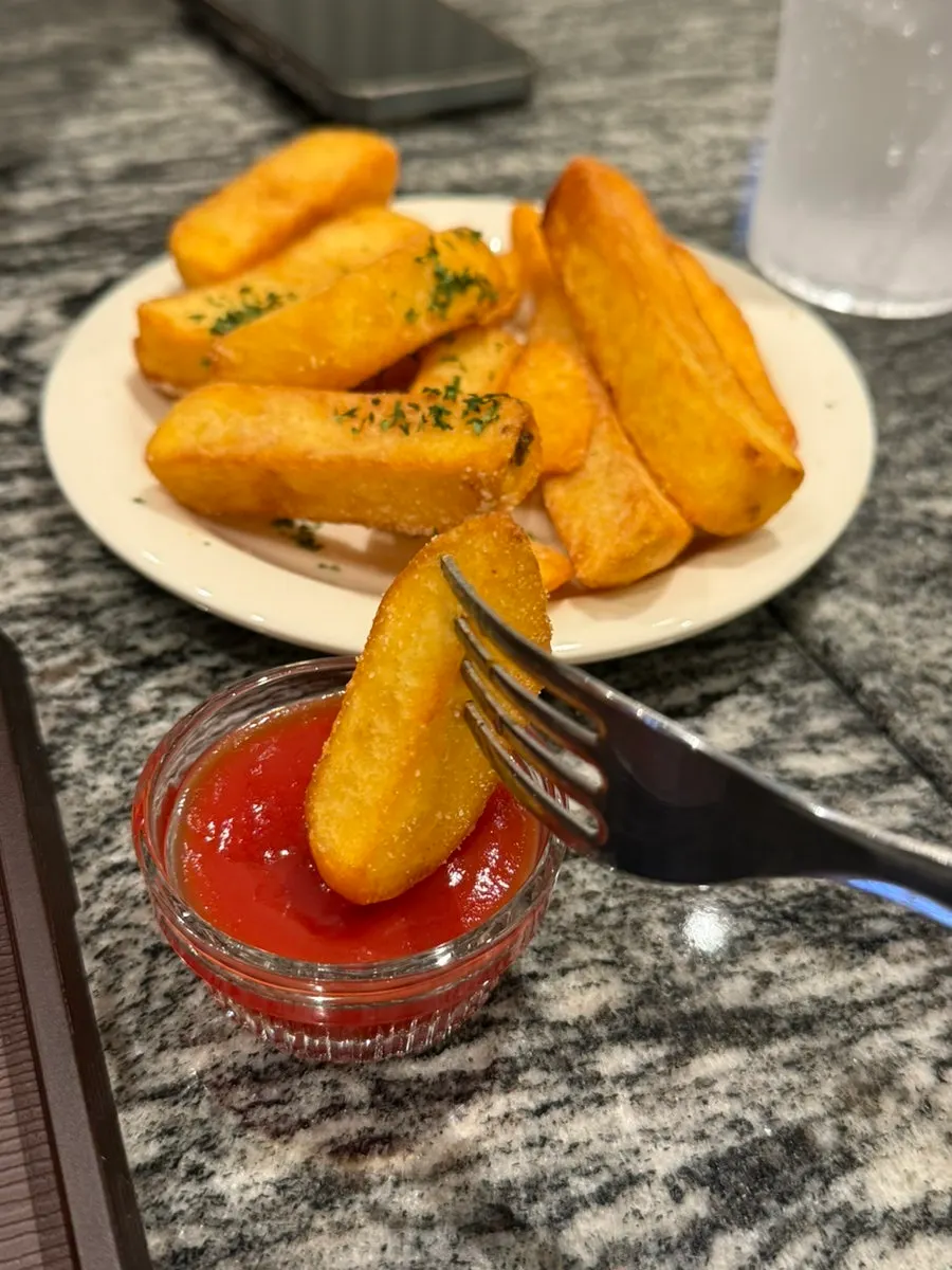 Close-up of freshly fried thick-cut fries