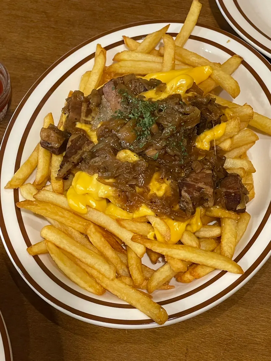A large plate of bacon cheese fries