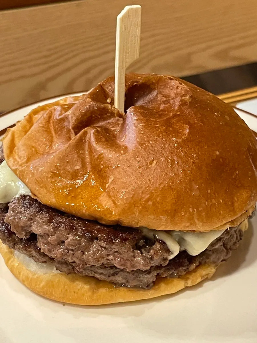Double cheese burger stacked with two patties and two cheese types